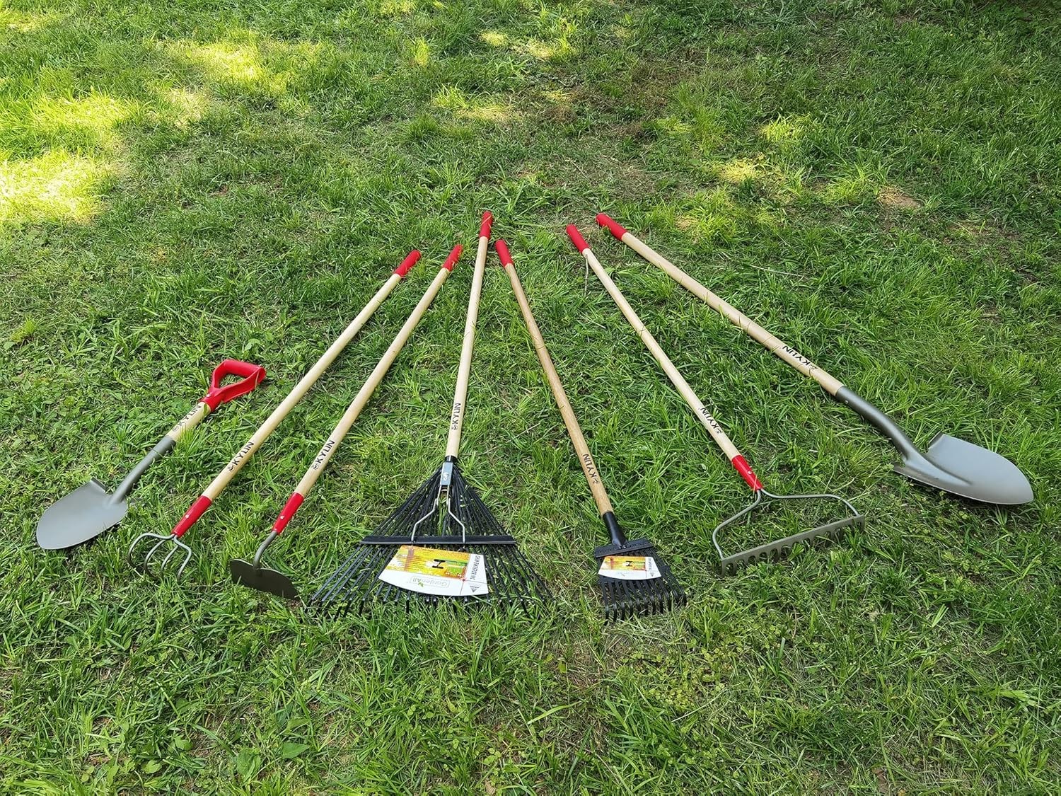 7-piece gardening tool set including shovel, rake, and hoe.